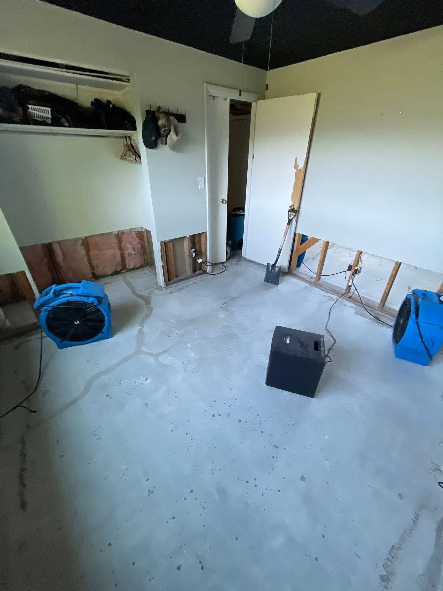 Flood cut in drywall with the cavity open and drying equipment running