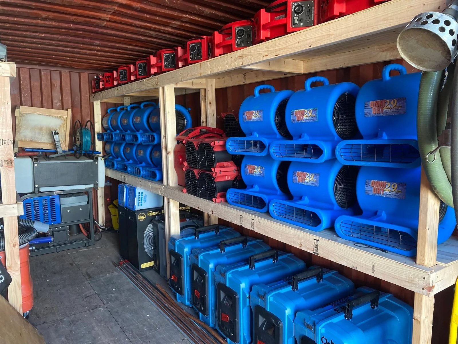 Racked air movers and dehumidifiers stored ready for deployment